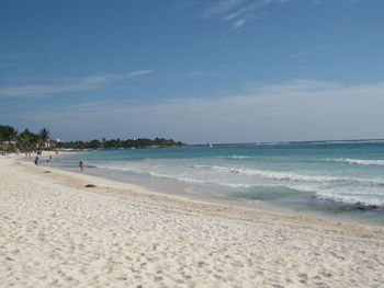 Scenic view of beach against blue sky