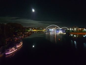 View of bridge over river at night