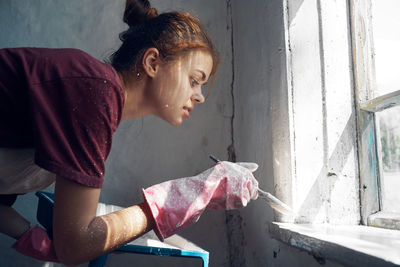 Young woman looking at camera at home