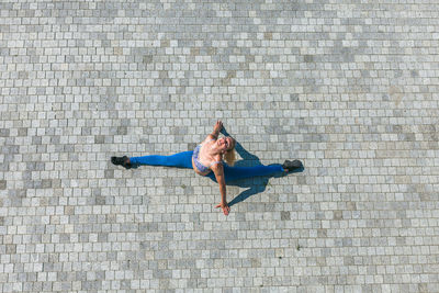 Rear view of man walking on footpath