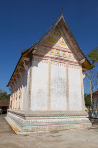 Low angle view of temple building against clear blue sky