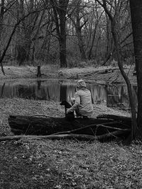 Man sitting on bare tree