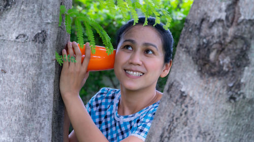 Portrait of smiling woman holding ice cream