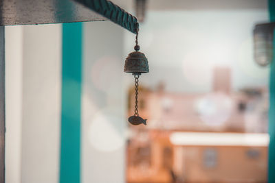 Close-up of electric lamp hanging in building