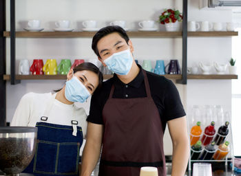 Portrait of young couple standing at home