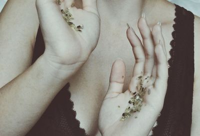 Midsection of woman with shimmer on hands