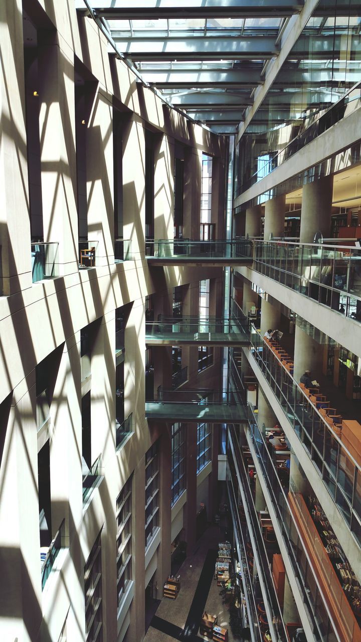 indoors, ceiling, architecture, built structure, in a row, modern, diminishing perspective, repetition, empty, interior, transportation, no people, high angle view, absence, pattern, day, the way forward, incidental people, architectural column, architectural feature