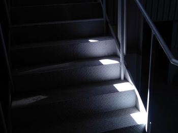 Cropped image of partially illuminated steel staircase