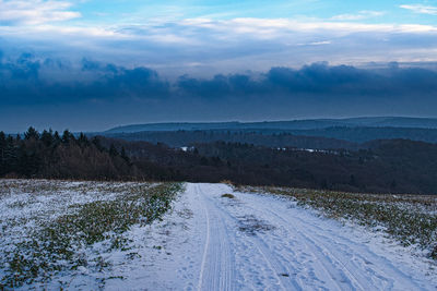 Scenic view of snow covered landscape against sky