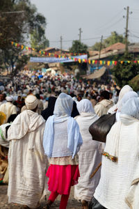 Rear view of people walking on street