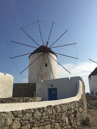 Low angle view of traditional windmill against sky