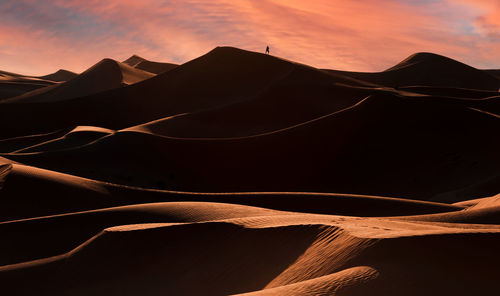 Scenic view of desert against sky during sunset