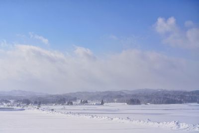 Scenic view of landscape against blue sky during winter