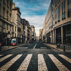 Street amidst buildings in city against sky