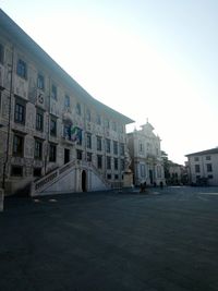 Buildings in city against clear sky
