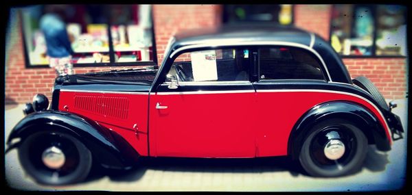 Close-up of vintage car on road