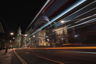 Light trails on urban street against built structures