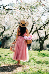 Woman standing on cherry blossom