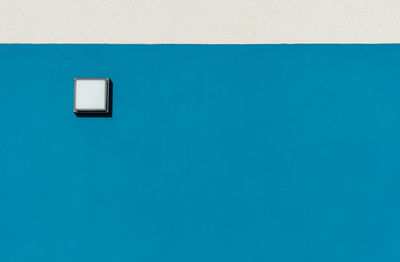 Close-up of light on blue wall