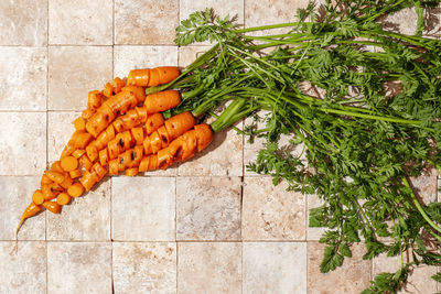 High angle view of chopped vegetables on tiled floor