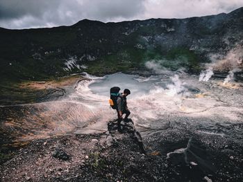 Rear view of man standing on mountain