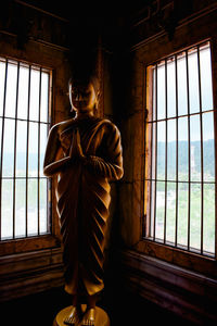 Man standing by window in building