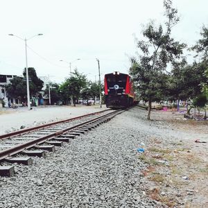 Train on railroad track against sky