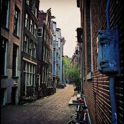 Road in front of building against sky