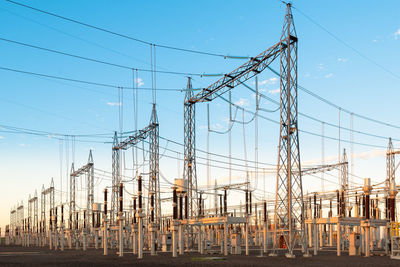 Low angle view of electricity pylon against sky