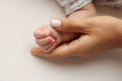 Close-up of hand against white background