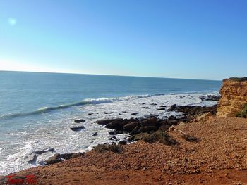 Scenic view of sea against clear blue sky