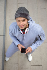 Portrait of smiling young man using mobile phone