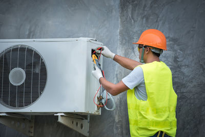 Worker repairing air conditioner