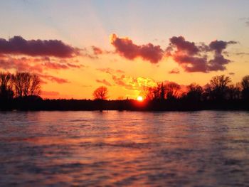 Scenic view of lake at sunset