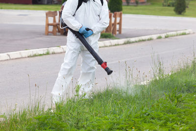 Man with umbrella walking on grass