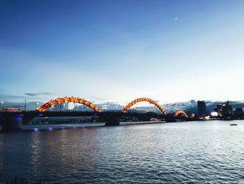 Bridge over river with city in background