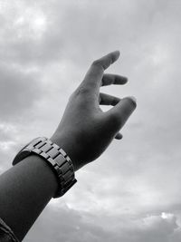 Low angle view of hand against sky