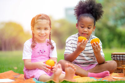 Portrait of a smiling girl sitting and outdoors