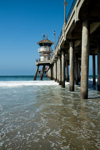 View of pier on sea against clear sky