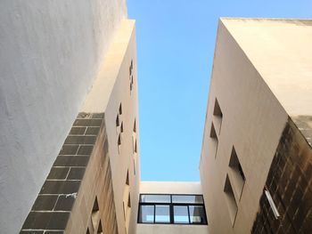 Low angle view of buildings against blue sky