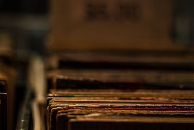 Close-up of old vinyls on shelf in store 