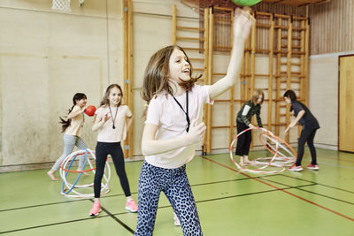 Children having pe class in school gym