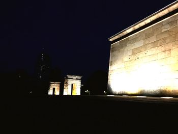 Low angle view of illuminated building against sky at night