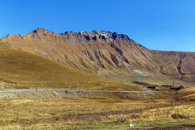 Scenic view of mountains against clear blue sky