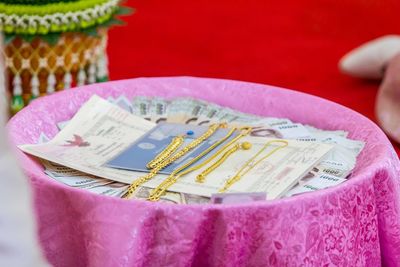 Close up of jewelries with paper and money in container