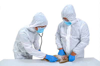 Rear view of doctor examining patient in hospital
