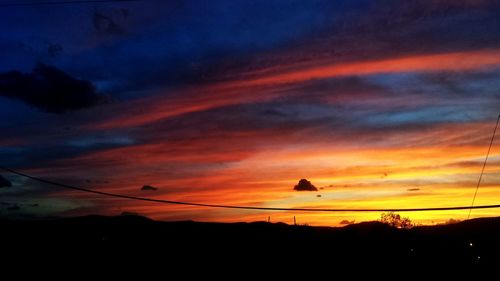 Low angle view of silhouette trees against sky at sunset