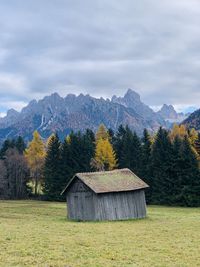 Built mountain structure on field against sky