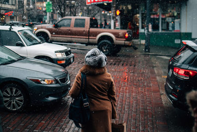 People on wet street in city during rainy season