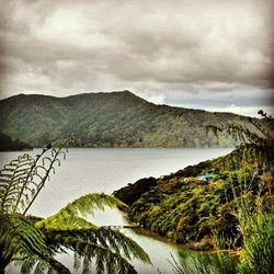 Scenic view of mountains against cloudy sky